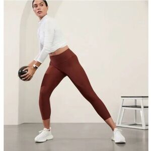 ATHLETA | SMALL INTERVAL STASH 7/8 TIGHT LEGGING BRONZE BROWN POCKETS